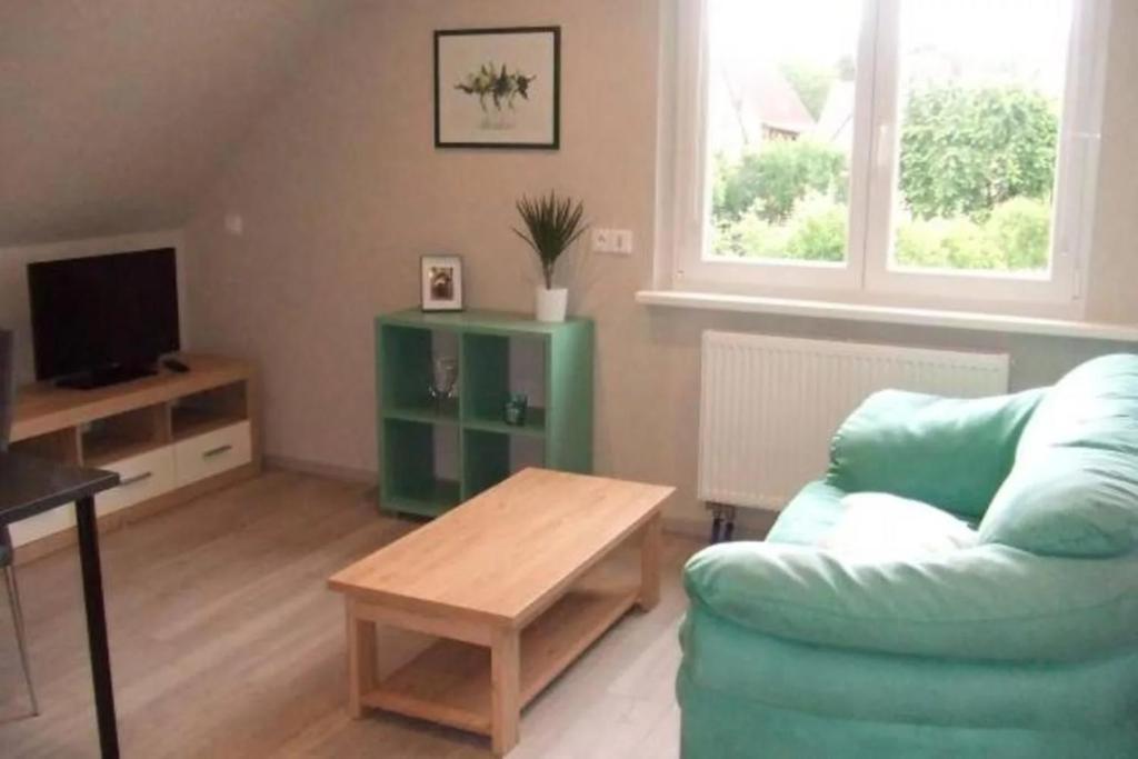a living room with a couch and a coffee table at Chambre D'hotes Clos Des Pommiers in Rosheim