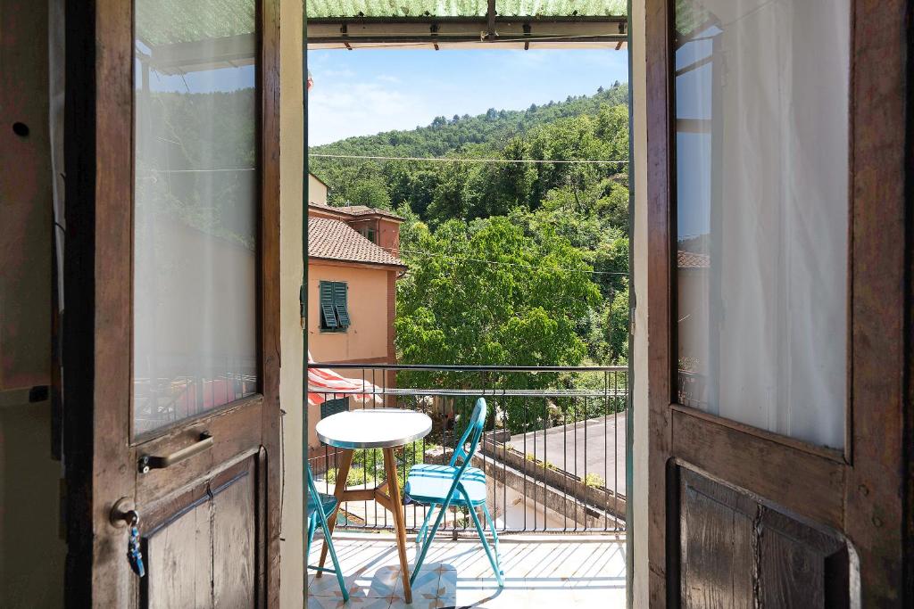 an open door to a balcony with a table and chairs at Acciuga House in Biassa