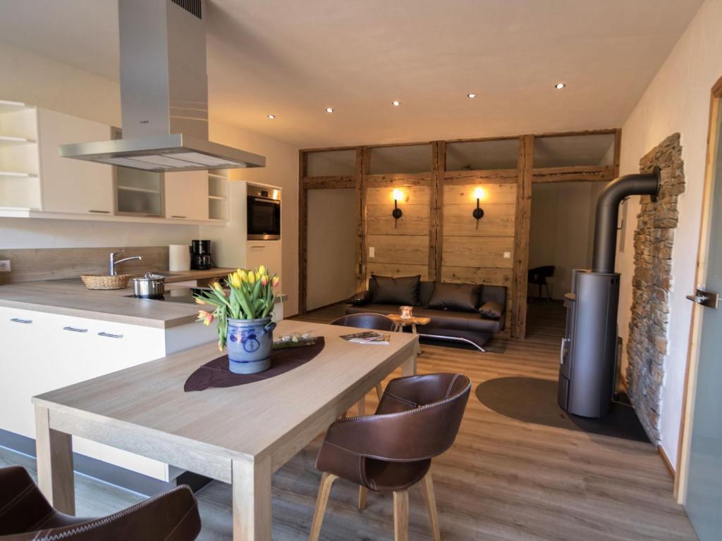 a kitchen and living room with a table and chairs at Ferienwohnung Maulbetsch in Alpirsbach