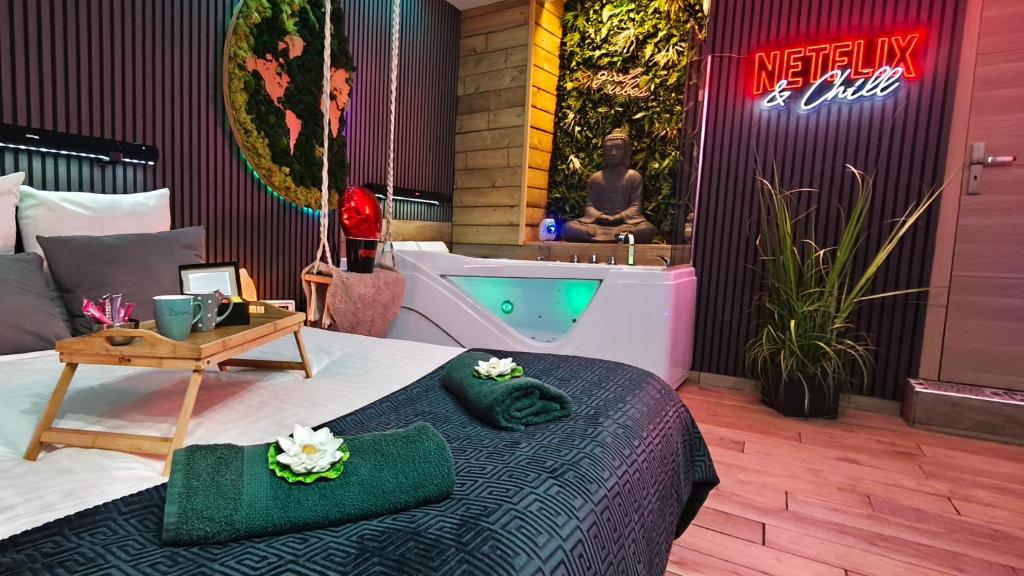 a hotel room with a bed and a bath tub at Eden SPA et Cinéma in Brie-Comte-Robert