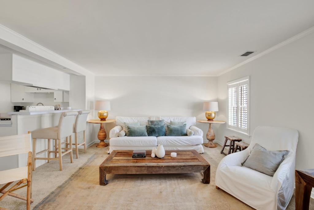 a living room with a couch and a table at Elsewhere on Madison Square Carriage House in Savannah