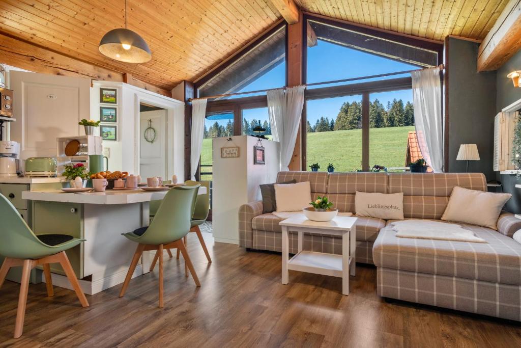 a kitchen and living room with a couch and a table at Haus Sonnenhang Wohnung 2 in Stiefenhofen