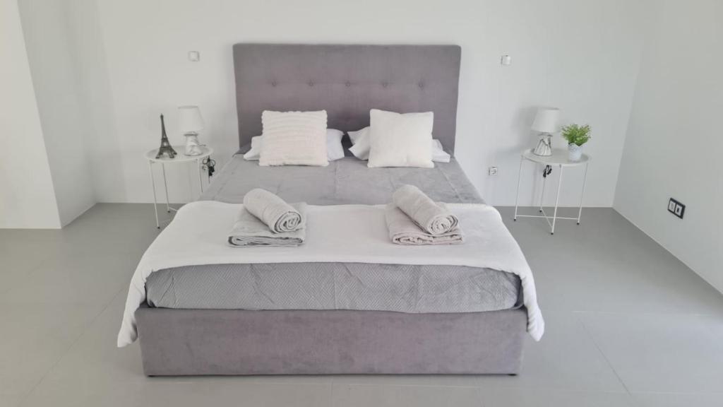 a bedroom with a large bed with two towels on it at Bella Casa - Suite in Angra do Heroísmo