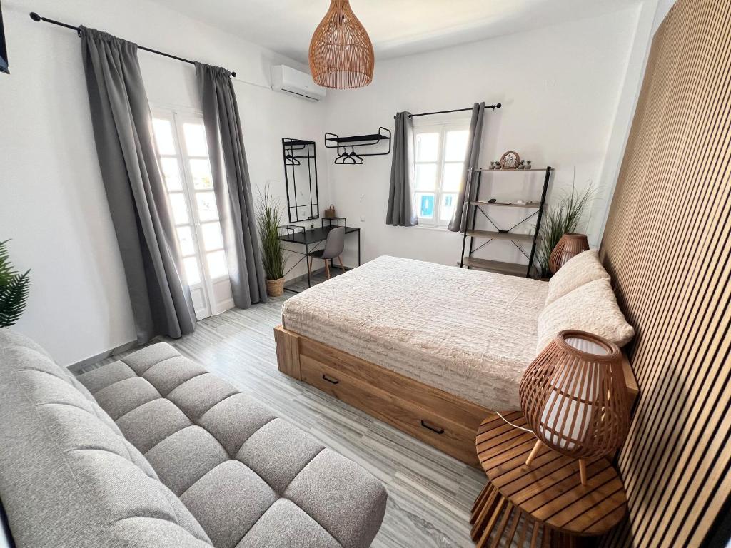 a bedroom with a bed and a couch at aeolian blu 2 in Parikia