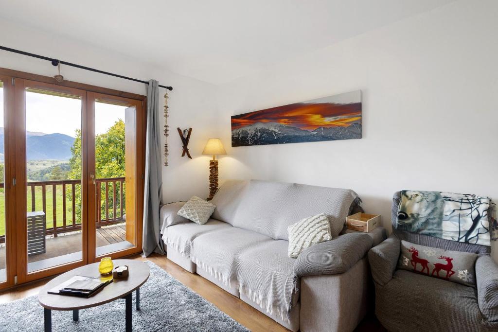 a living room with a couch and a table at Apto Unico En Font Romeu in Font-Romeu