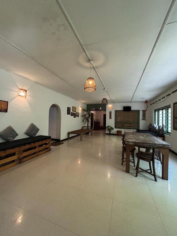 a large living room with a table and a couch at Backpackers in Matara