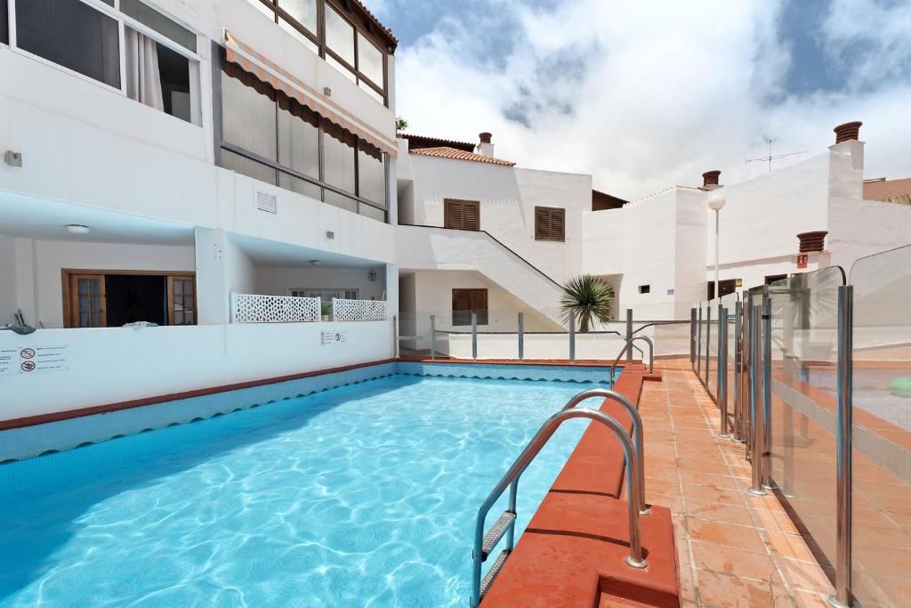 a swimming pool in front of a house at Apartment Colina Vista in Los Cristianos