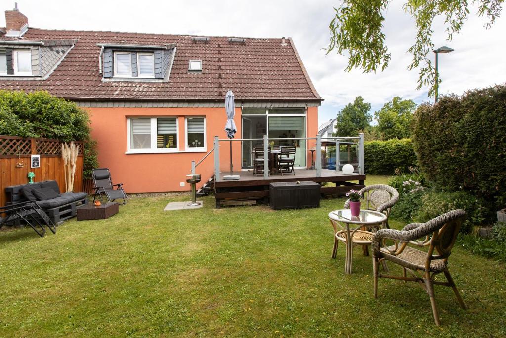 a house with a yard with chairs and a table at Ferienhaus Koch in Bad Harzburg