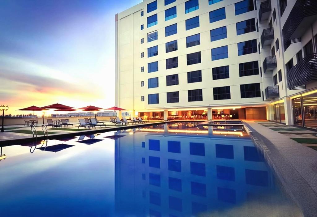 a hotel with a pool in front of a building at GR Ming garden SCSP in Kota Kinabalu