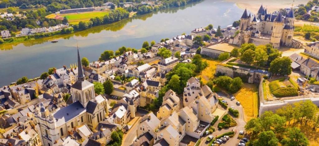 an aerial view of a town next to a river at Petite maison dans centre ville in Saumur