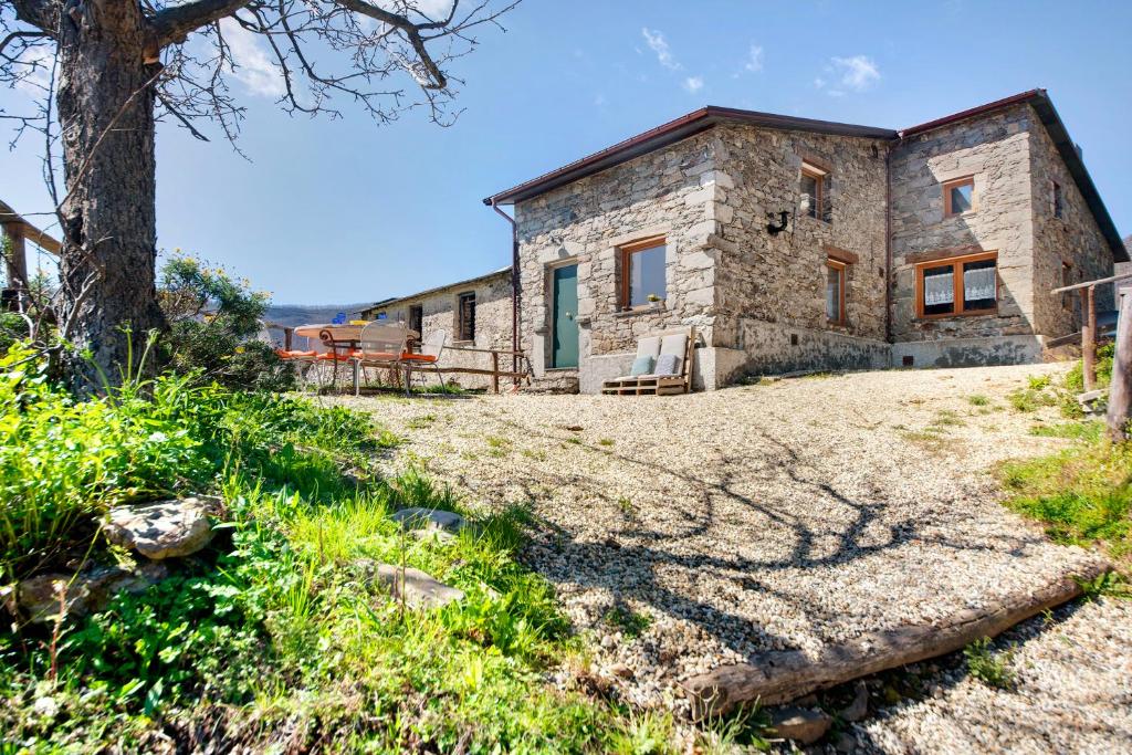 an exterior view of a stone house on a hill at Nature House Custu Giancu in Cichero