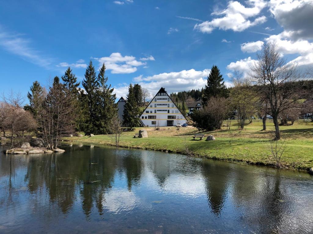 a house on the side of a river at 2 Zimmer Wohnung, mit Sonnenterasse in Schonwald im Schwarzwald