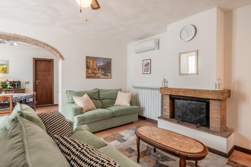 a living room with a couch and a fireplace at Casa Simi - Holiday Home in Chiesina Uzzanese