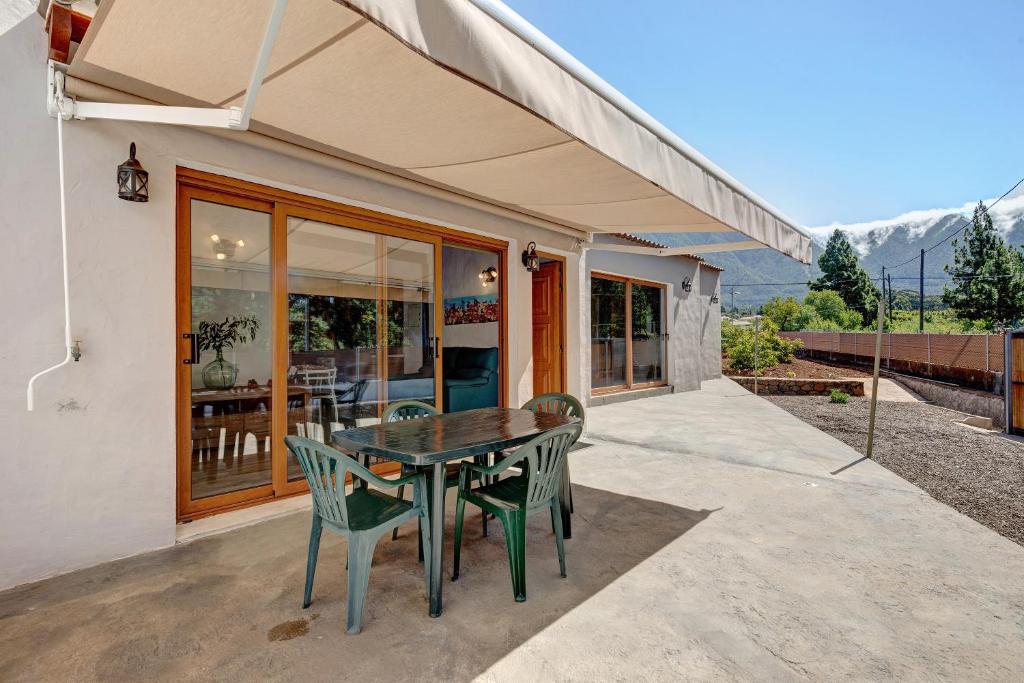 a house with a table and chairs on a patio at Casita Ana in El Paso