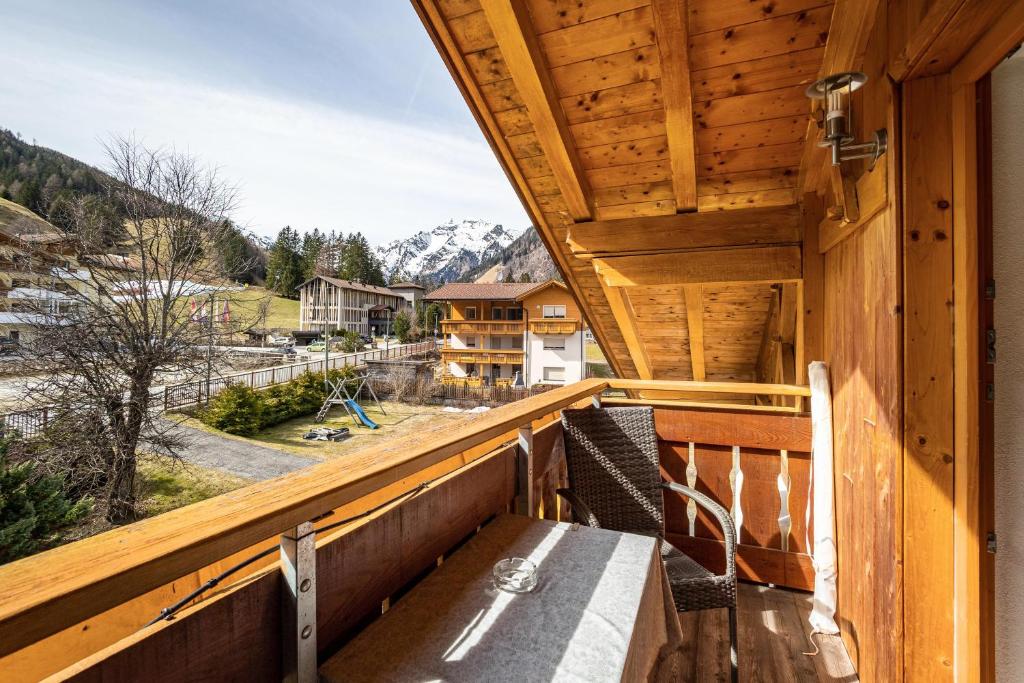 a wooden balcony with a view of a mountain at Gartnerhof Apt Sonnenblume in Fleres