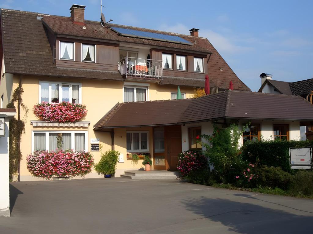 a large yellow house with a brown roof at Gästehaus Fischerhäusle in Mitten