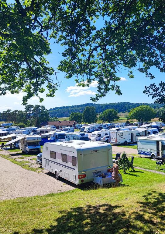 a rv parked in a field next to a bunch of rvs at Unda Camping & Resort in Uddevalla