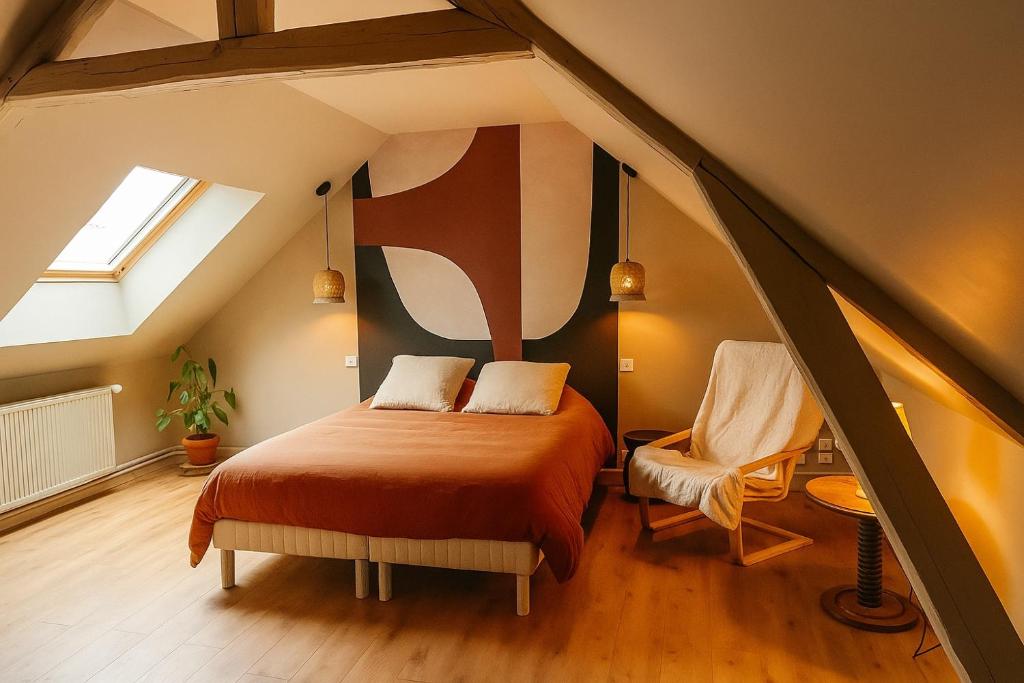 a attic bedroom with a bed and a window at Logement refait à neuf ! in Bois-Guillaume