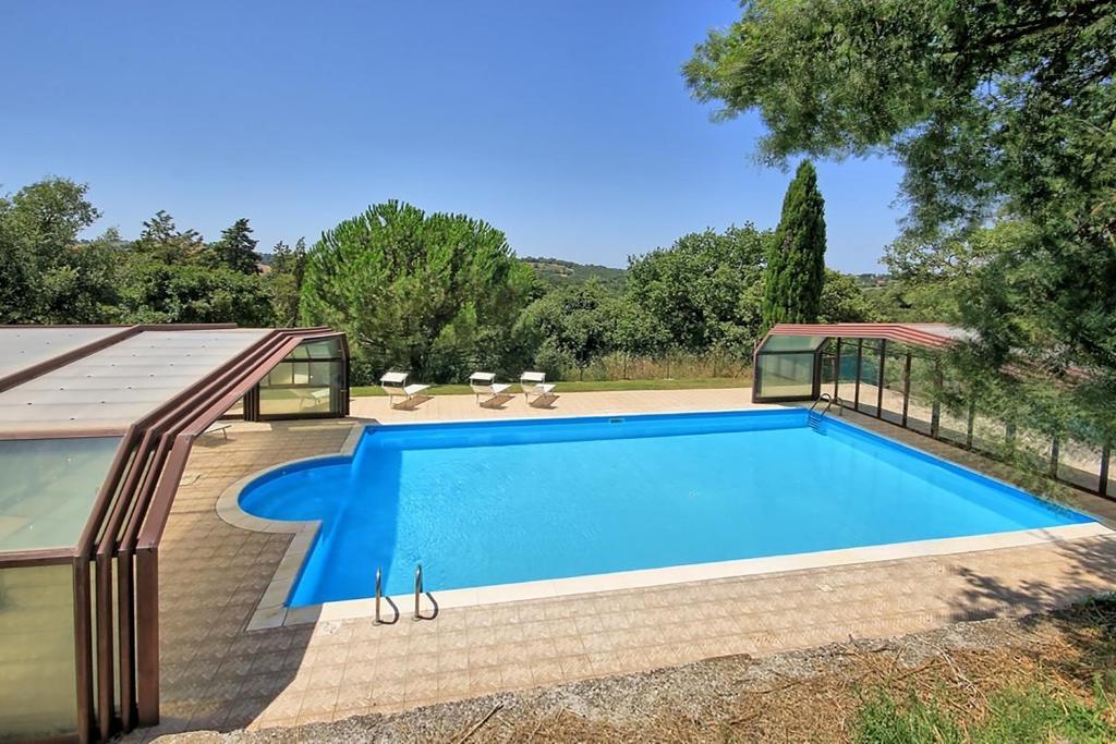 a swimming pool in a backyard with a house at Casale Mulino in Pancole