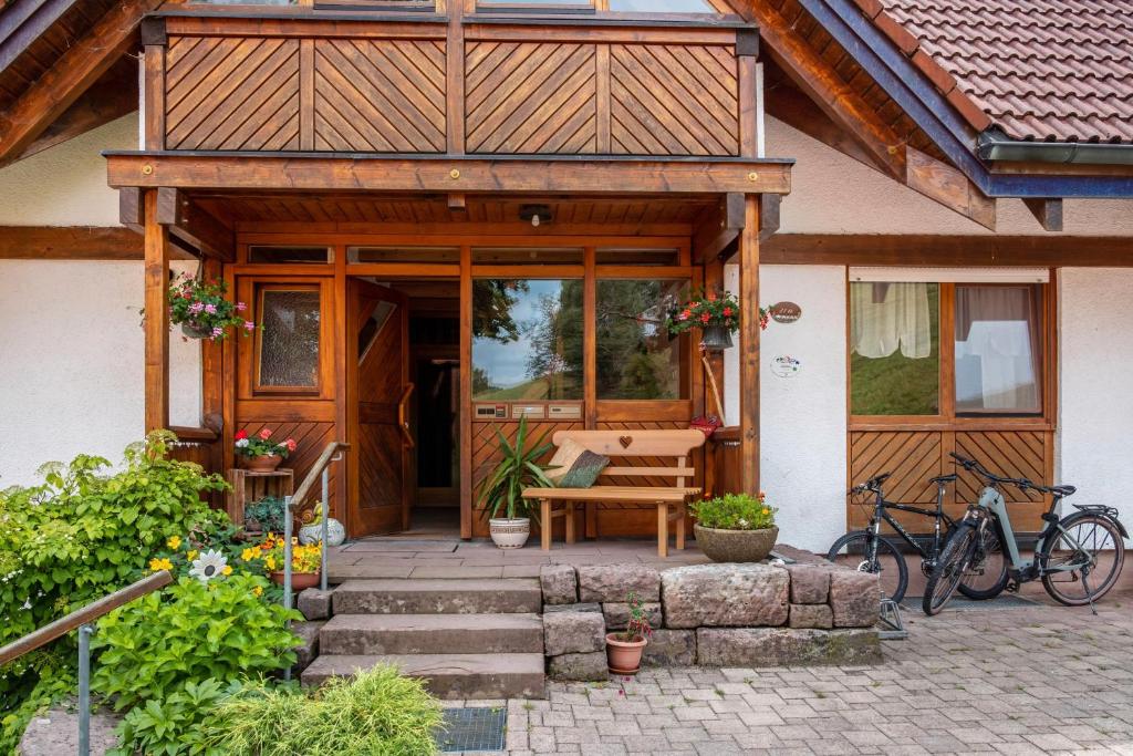 a porch of a house with a bench and a table at Ferienwohnung Weiherblick in Hornberg