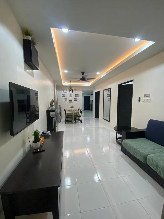a large living room with a couch and a tv at Homestay Casa Cinta Pendang in Pendang