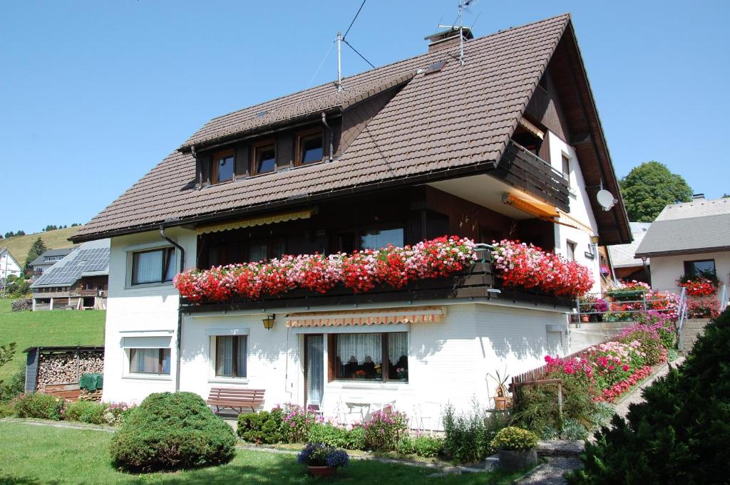 a house with flowers on the side of it at Ferienwohnung Karrach in Bernau im Schwarzwald