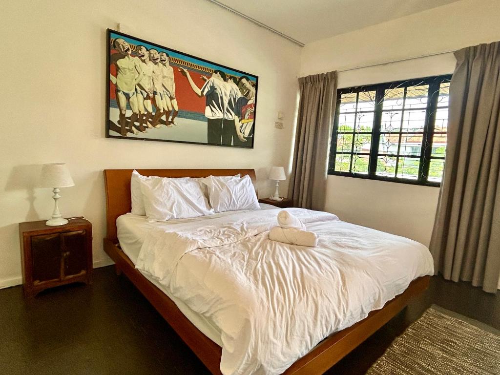 une chambre avec un lit avec un ours en peluche dessus dans l'établissement Cozy Family Homestay 2BR with Balcony in Shared Bungalow SS2 PJ, à Petaling Jaya