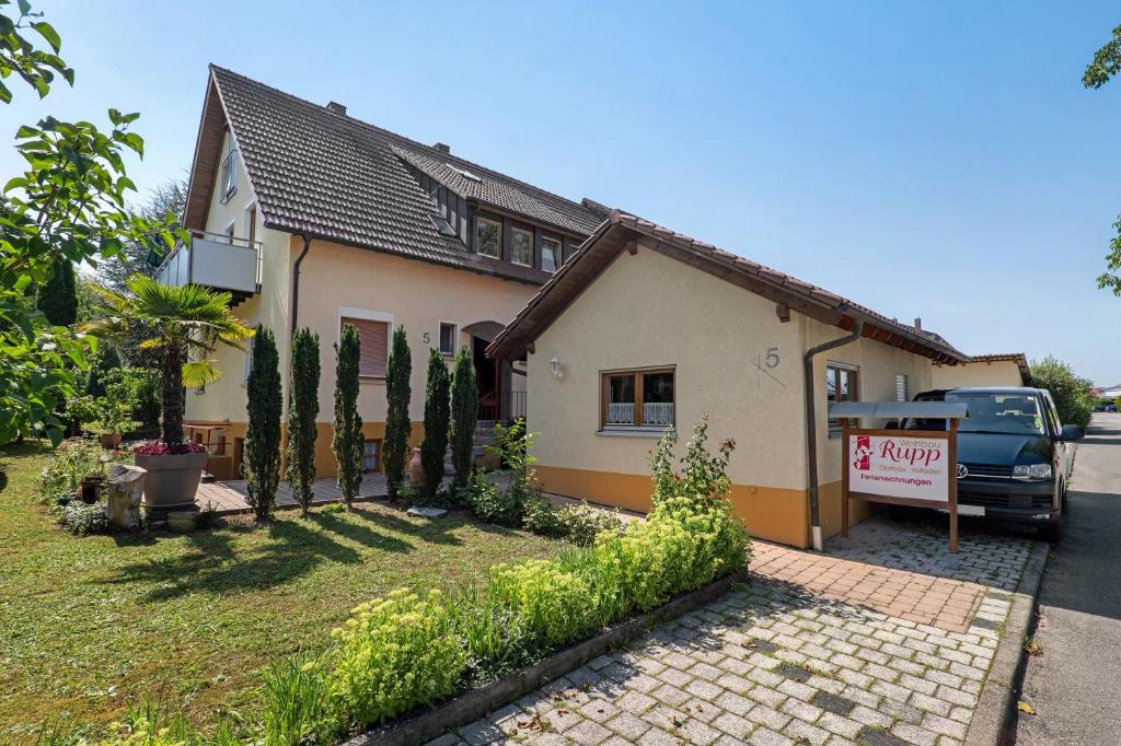 a house with a car parked in front of it at Wein- Und Obstbau Rupp in Obersulm