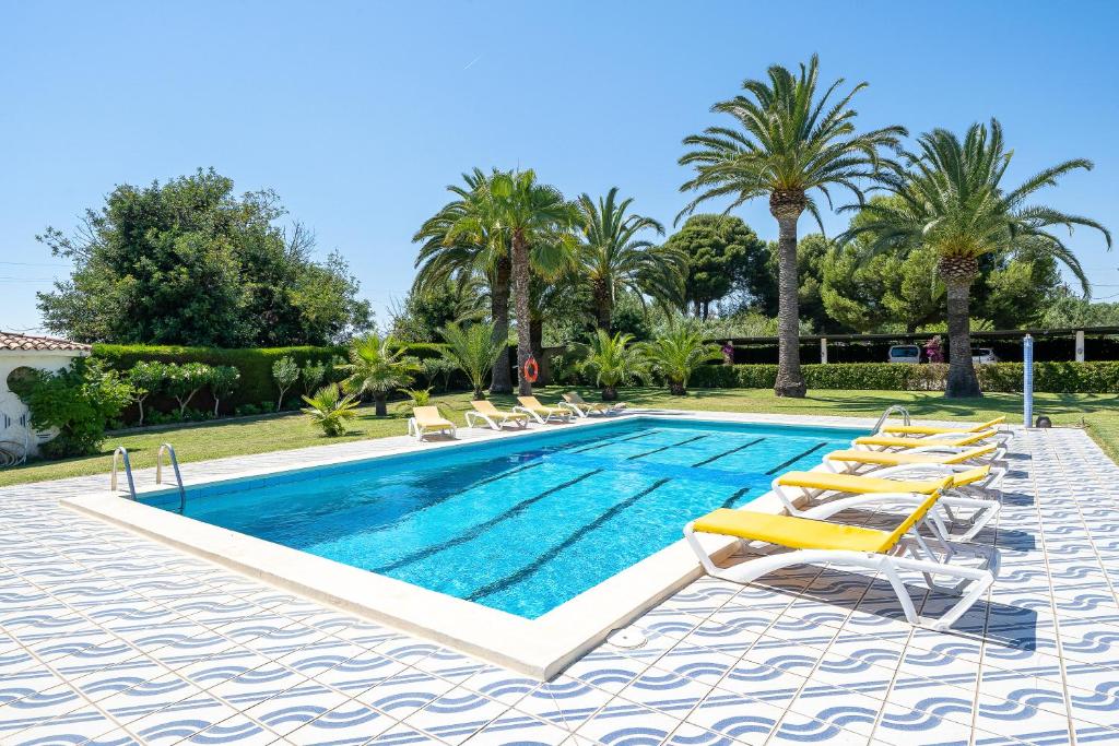 a swimming pool with chaise lounge chairs and a resort at Complejo Colibri 13 in Cambrils