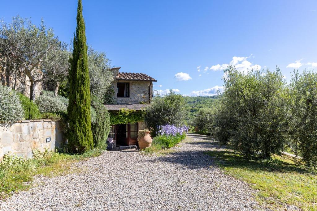 a house with trees and a gravel driveway at Casa al Poggio and Chianti view in San Donato in Poggio