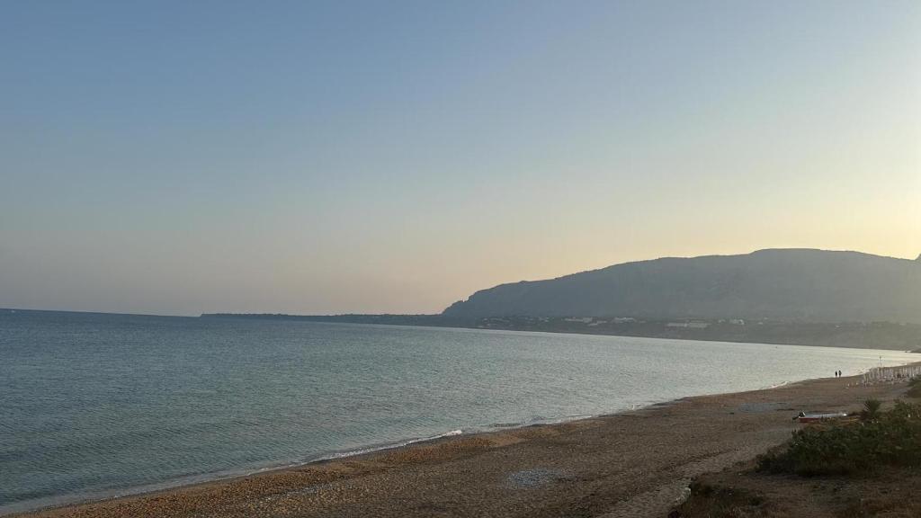 a beach with a group of people in the water at Venti Del Mare in Trappeto