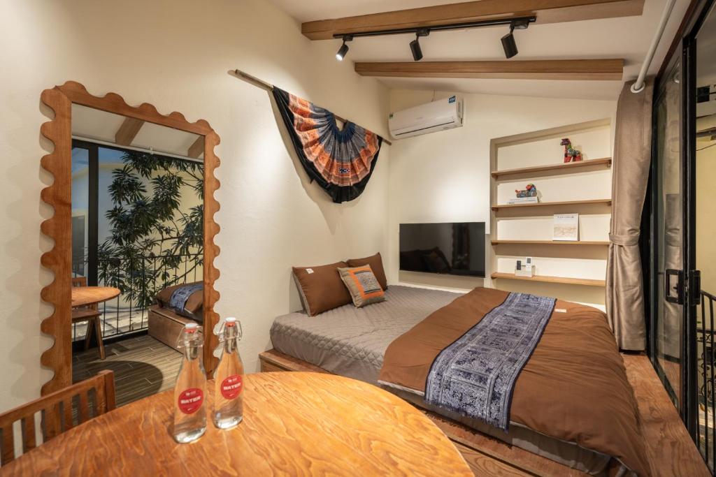 a bedroom with a bed and a table and a mirror at Lakeside Horizon Boutique Suites-1 min to Hoan Kiem Lake-Free Airport in Hanoi