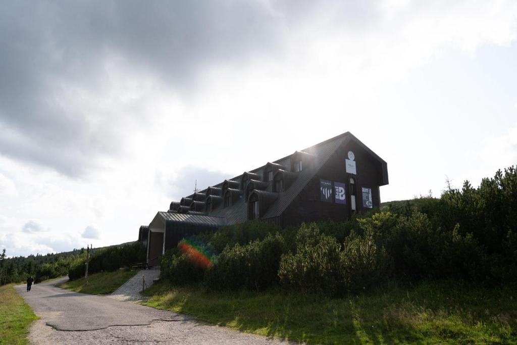 a building on the side of a hill at Výrovka in Pec pod Snezkou