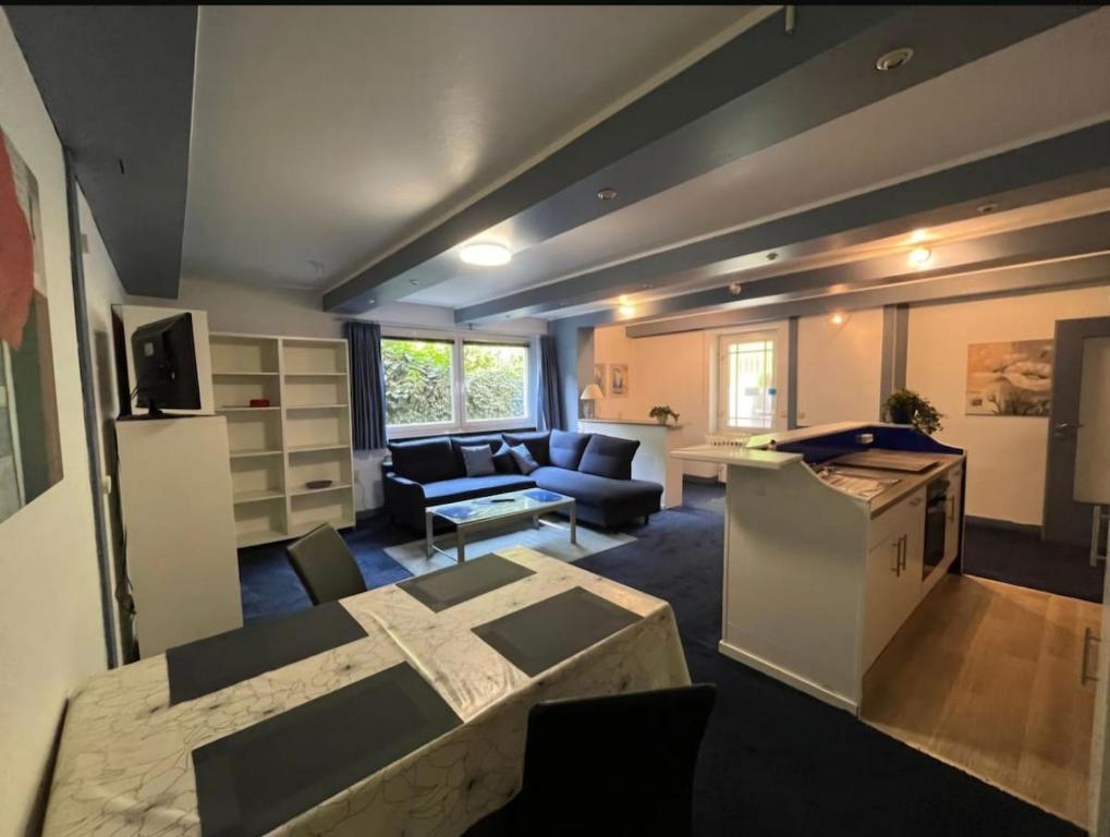 a kitchen and living room with a couch and a table at Wohnung Blume in Niederdorla
