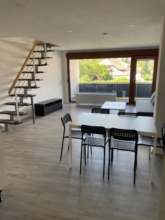 a room with chairs and a table and stairs at Geräumige Ferienwohnung Eschelbronn in Eschelbronn