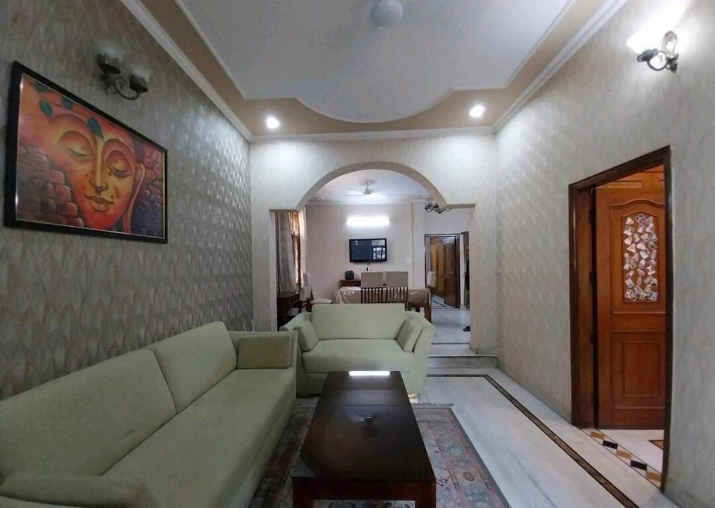 a living room with a couch and a table at 2BHK Central Gurgaon in Gurgaon