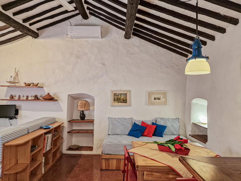 a living room with a couch and a table at Il Borgo 5 in Capoliveri