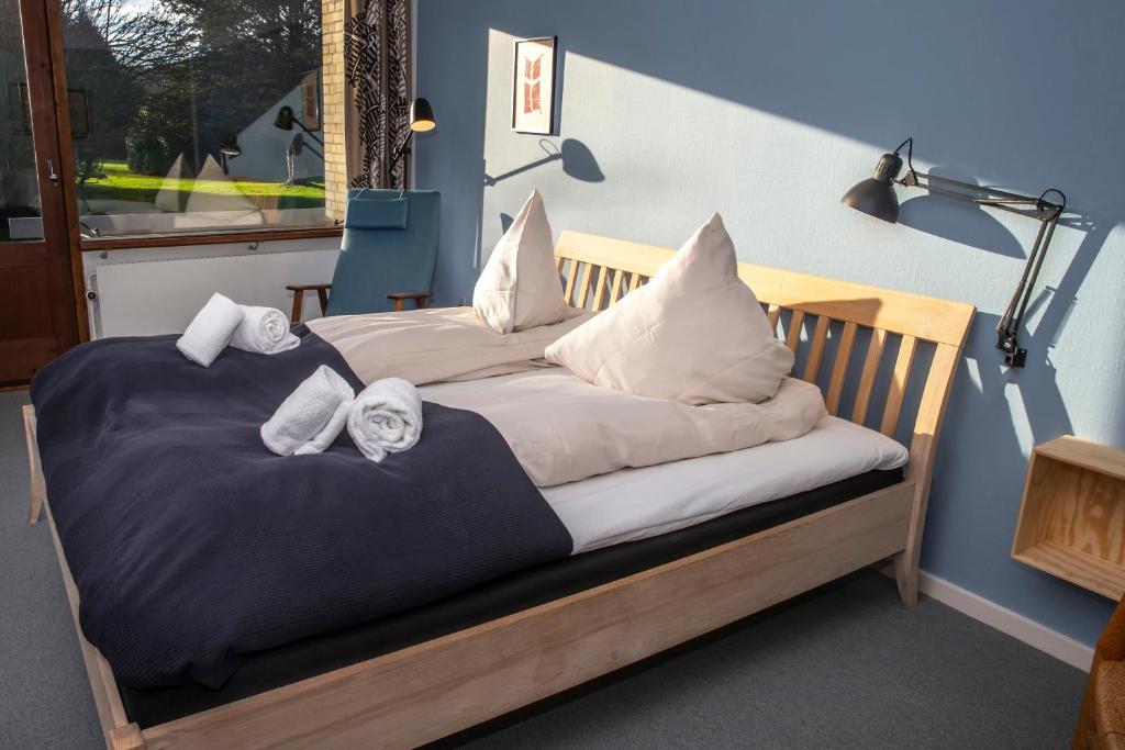 a bedroom with two beds with pillows on them at Fuglsang Have B&B 