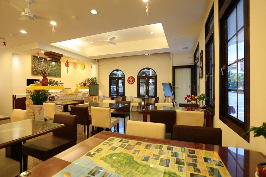 a restaurant with tables and chairs and a lobby at Love in Hualien B&amp;B in Hualien City