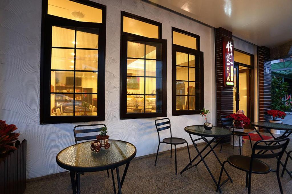 a room with two tables and chairs and windows at Love in Hualien B&amp;B in Hualien City