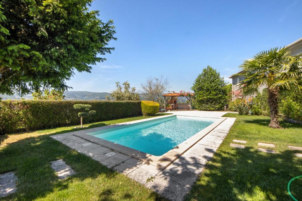 a swimming pool in the yard of a house at Casa do Valado in Resende
