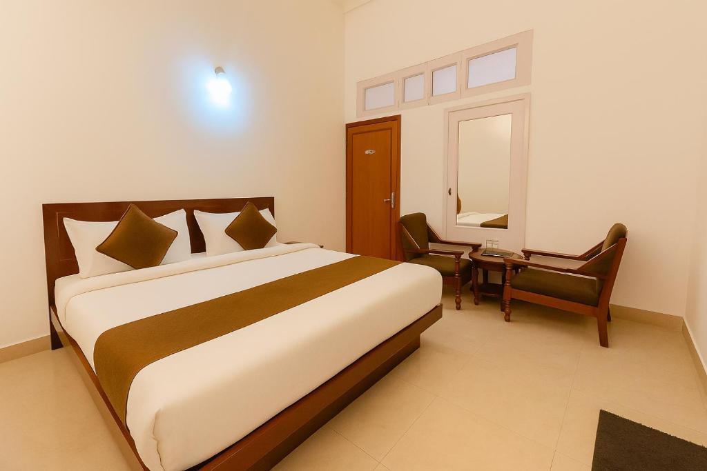 a bedroom with a bed and a desk and a chair at Hotel Sunny Cot - Free Mall Shuttle and Parking in Mussoorie