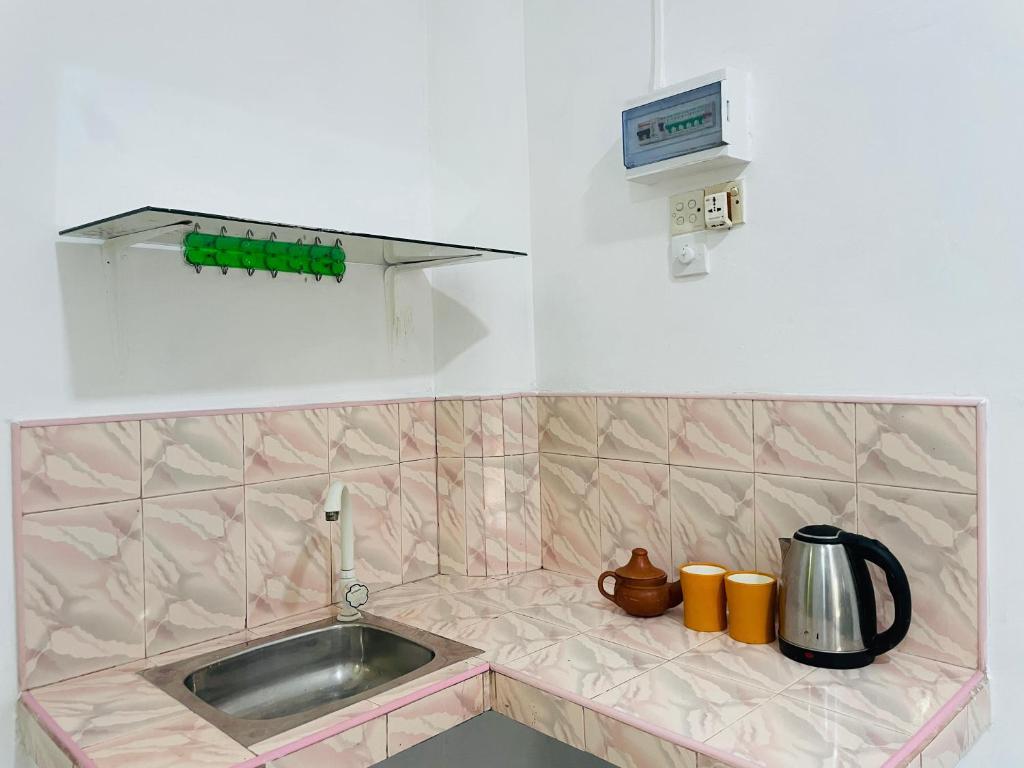 a kitchen with a sink and a counter top at Lakru Home Stay in Weligama