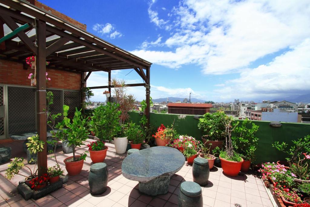 a patio with a table and potted plants at Love in Hualien B&amp;B in Hualien City