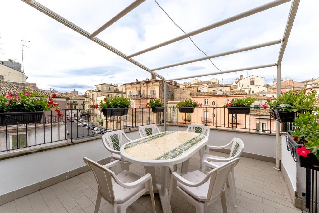 a patio with a table and chairs on a balcony at La Terrazza House in Lanciano