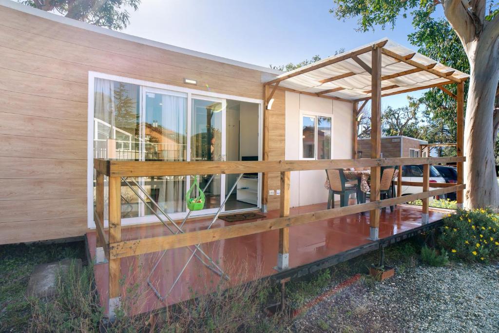 a modular house with a porch and a deck at New Generation La pineta 7 in Albenga
