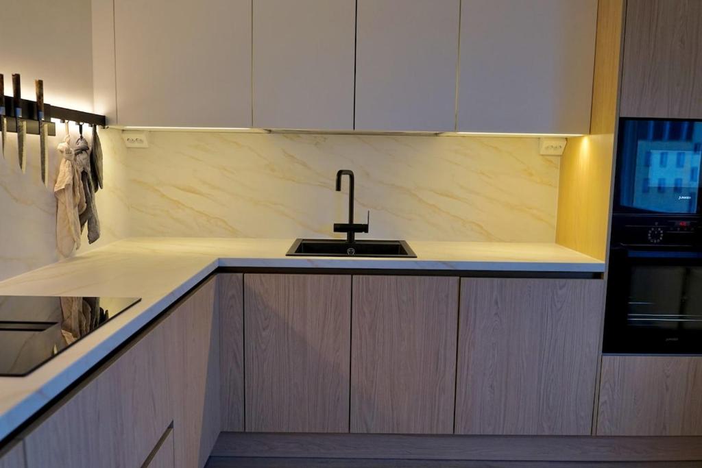 a kitchen with a sink and a counter top at Bright Elegant - Feel Lapland with light & harmony in Rovaniemi