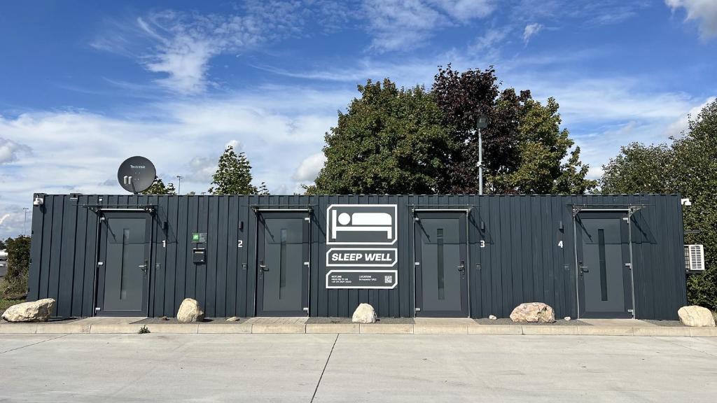 a black building with doors and a sign on it at Roatel Schopsdorf A2 my-roatel-com in Schopsdorf