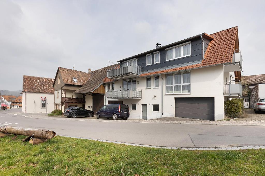 a house with a car parked in the driveway at Obstbau Koch in Bodman-Ludwigshafen