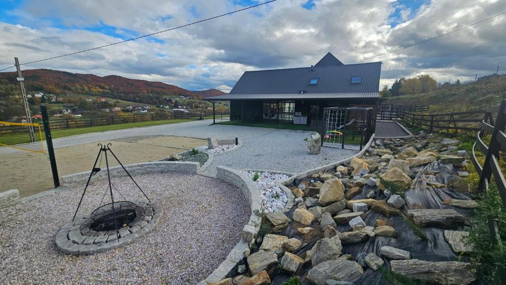 ein Gebäude mit einem Steingarten vor einem Gebäude in der Unterkunft Secret Barn in Michalczowa